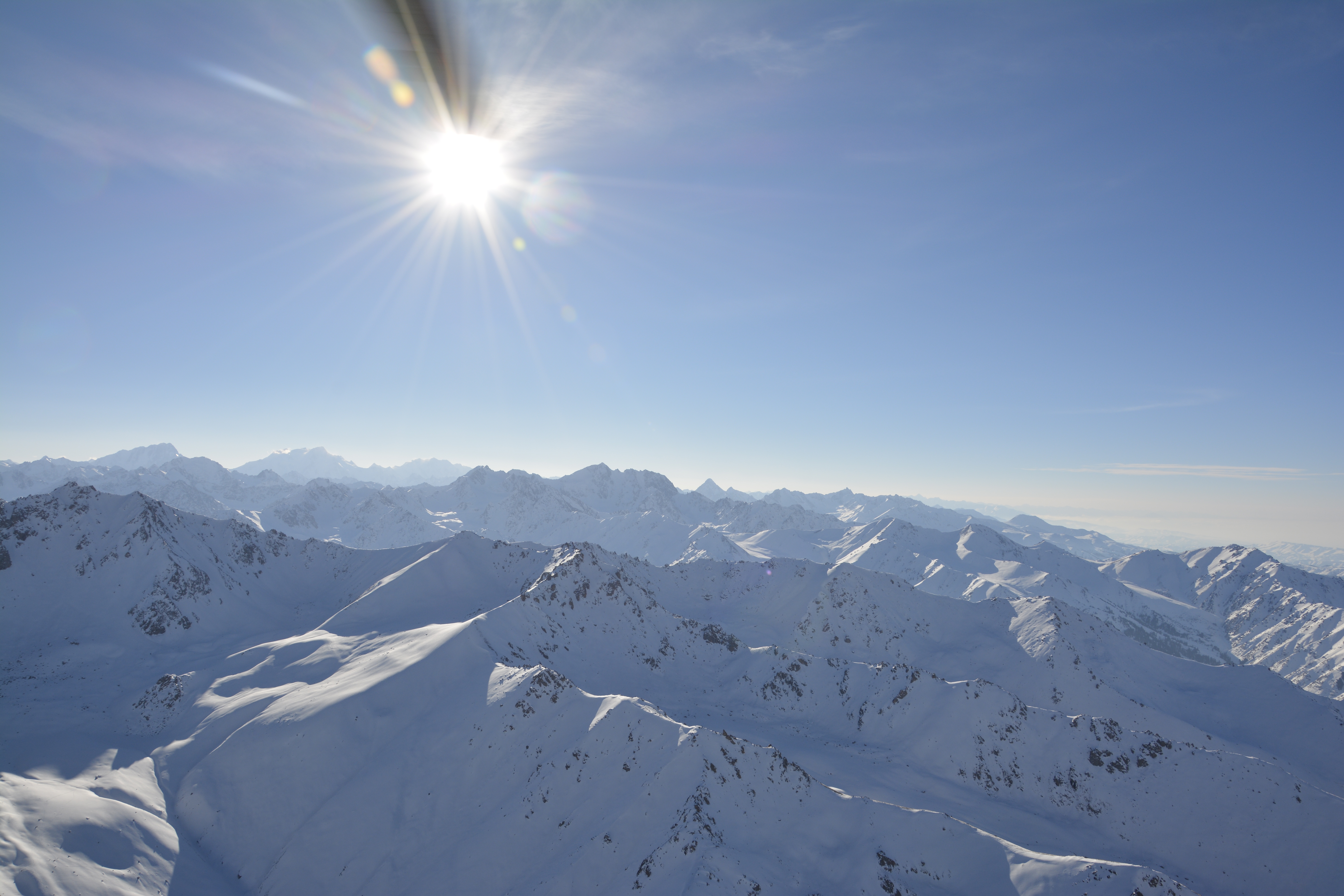 Wide alpine massif at dusk — muted, documentary, unstaged.